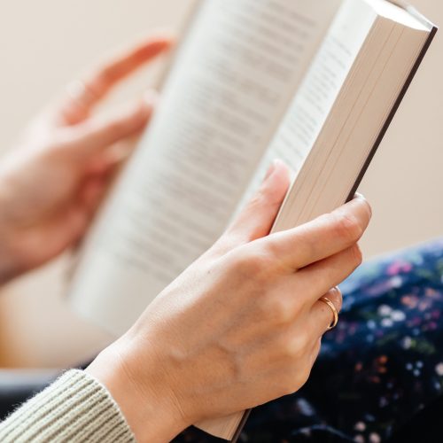 female hands holding a book to read